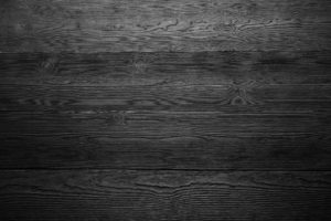 Dark wood background in black and white. Close up of wall made of wooden planks